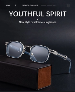 Macro view of blue oval sunglasses with silver metal bridge on black leather case