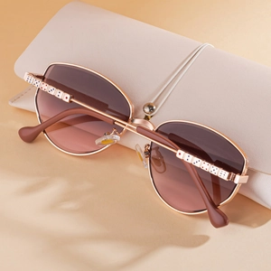 Chic polygonal rose gold metal sunglasses for women with a cream leather case
