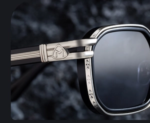Macro view of square frame sunglasses featuring a silver M logo and diamond texture details