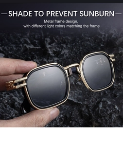 Detailed close-up of golden metal frame sunglasses with intricate engraved patterns