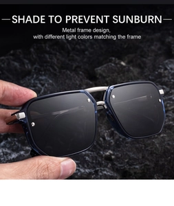 Detail of square polarized sunglasses with blue frame and metal bridge on rock surface