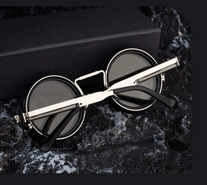 Steampunk round sunglasses with silver metal frame and spring temple detail on dark rock