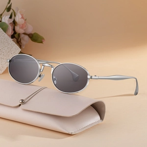 Oval silver metal frame sunglasses with dark lenses and cream leather pouch