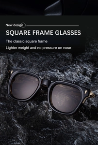 Close-up of black square sunglasses with golden arrow hinges on a textured stone surface