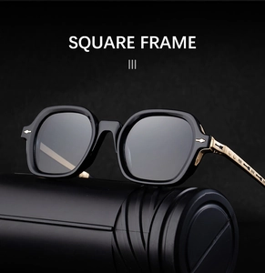 Detailed view of black square sunglasses featuring gold metal temples and arrow hardware