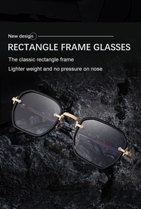 Detail view of retro rectangle sunglasses with golden metal hinges on dark rock background