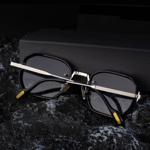Detail of silver textured metal temples and yellow accents on square sunglasses