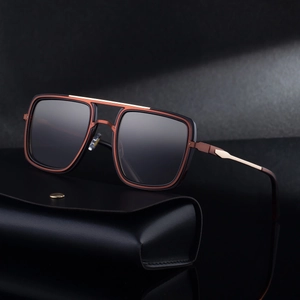 Modern square pilot sunglasses with black metal frame and grey lenses on leather case