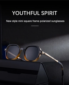Detail of square polarized sunglasses with black-yellow gradient frame and gold temples