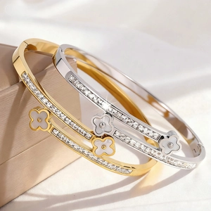 Sparkling silver and gold stainless steel bangles with clover and shell inlay