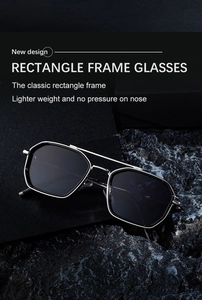 Detail of square silver metal sunglasses with lightweight double-bridge design on stone