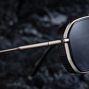 Detailed macro view of square punk sunglasses featuring silver frames and black mesh side shields