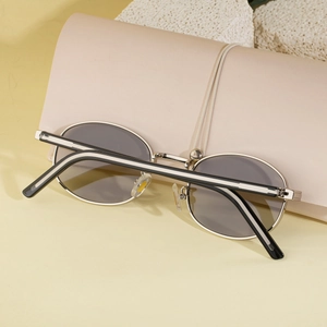 Retro oval metal sunglasses in silver with grey lenses and a beige leather case