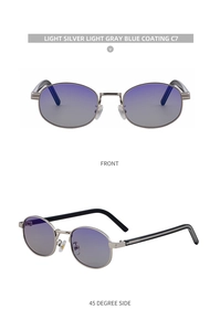 Detail view of oval light silver metal sunglasses with light gray blue gradient lenses