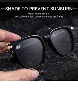 Detail of black polygon sunglasses with thick frame and gold metal hinge accents