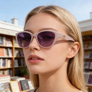 Fashion cat-eye polarized sunglasses with pink frame and purple lenses worn outdoors