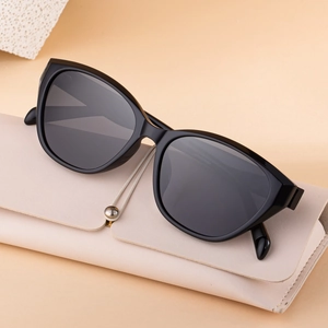Cat eye polarized sunglasses for women leaning on a beige leather glasses case