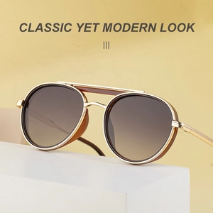 Detail of vintage aviator sunglasses featuring a gold metal frame and brown gradient lenses