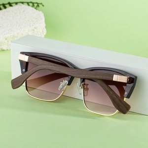 Detail of retro cat-eye sunglasses with gradient lenses and wood grain textured temples