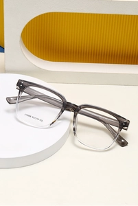 Detailed view of square gradient gray eyeglass frame with model J10008 on white platform