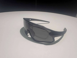 Detail of matte black cycling sunglasses featuring a removable inner prescription frame
