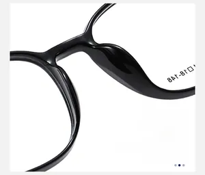 Detailed macro view of the integrated nose pads on glossy black square eyeglass frames