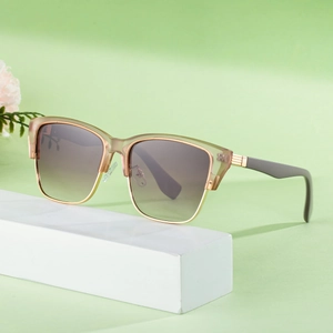 Retro cat-eye sunglasses with champagne frames and wood-grain temples on display stand