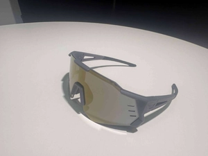 Close-up of golden sports shield lens with side ventilation holes for anti-fog protection