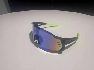 Detail of sports sunglasses with colorful gradient lens and neon green anti-slip temple tips