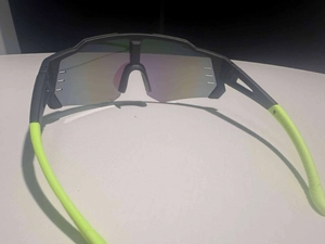Detail of sports sunglasses with Revo coated lens, vents and neon yellow temples