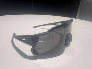 Detail view of matte black sports sunglasses featuring side temple ventilation holes
