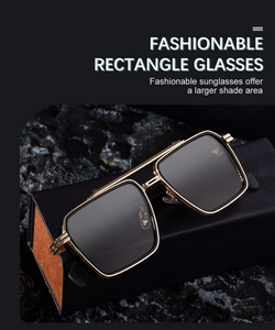 Detail of square gold and black metal sunglasses frame on a leather case background