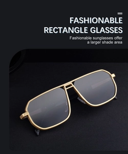Close-up of golden rectangular metal frame sunglasses with large grey polarized lenses