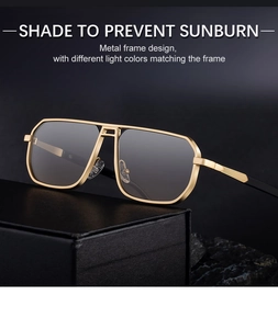 Close-up of golden metal frame sunglasses with textured stripe detailing on temples