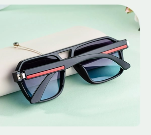 Detail of square polarized sunglasses with red stripes on temples and a leather case