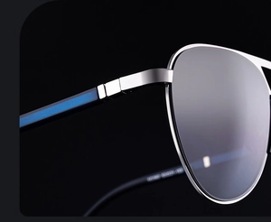 Close-up of silver metal frame with blue stripe detailing on the temple of sunglasses