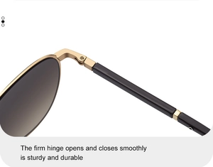 Macro shot of durable gold metal hinge and sleek black temple on aviator sunglasses