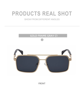 Detailed close-up of gold double-bridge frame sunglasses with gray lenses on white background