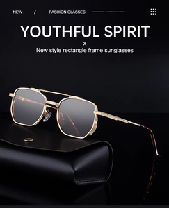 Detail view of rectangle gold metal frame sunglasses with a black leather eyewear case