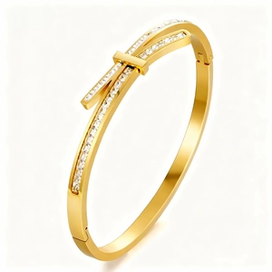 Elegant gold bow-shaped titanium steel bracelet with micro-pave crystals and side hinge