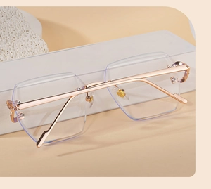 Detail of rimless hexagonal sunglasses with rose gold metal temples and crystal accents