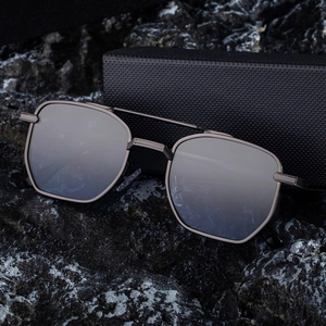 Classic square metal frame sunglasses with dark lenses on a textured stone background