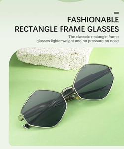 Détail de lunettes de soleil polygonales légères avec monture en métal argenté sur pierre