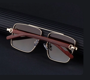 Macro detail of square metal frame sunglasses with wooden texture temples and C-hinge