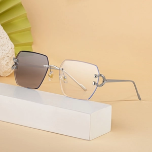 Fashionable rimless photochromic sunglasses with silver metal C-shaped crystal hinge detail