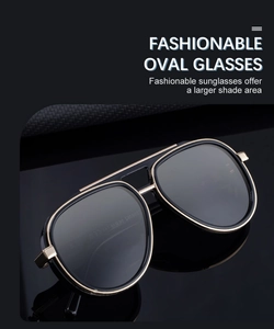 Detailed side view of classic pilot sunglasses with gold metal frame and black lenses