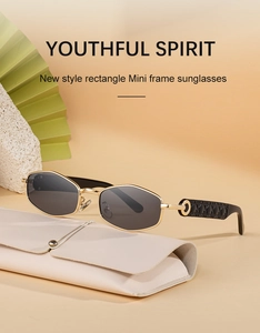 Detail of vintage mini rectangle sunglasses with gold frames on a cream leather case