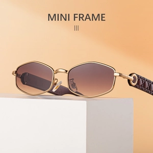 Detail of polygonal gold metal frames and brown gradient lenses on trendy sunglasses