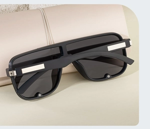Detail of square polarized sunglasses with matte black frames and silver metal accents