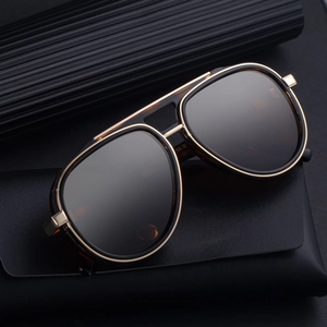 Classic aviator sunglasses with tortoise frames and black lenses over a leather case